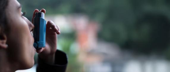 Woman using inhaler