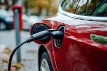 Red electric car being charged