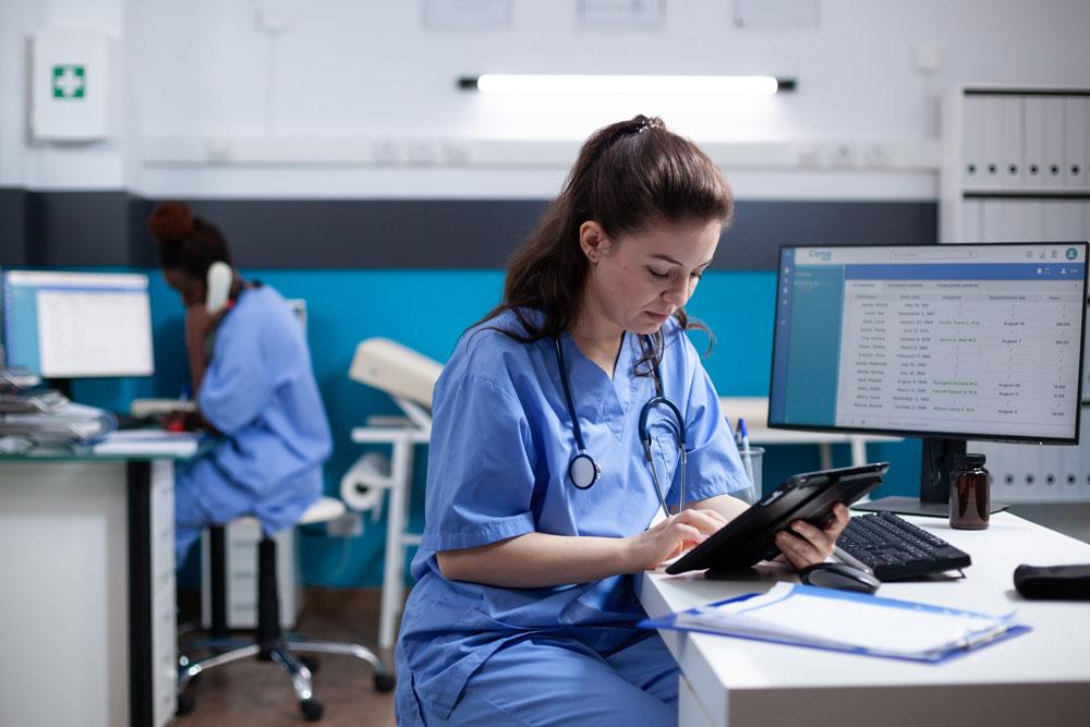 Young healthcare professional in office on tablet